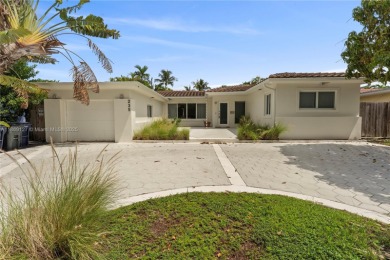 Beautiful light and bright pool home in a gated residential golf on Normandy Shores Golf Course in Florida - for sale on GolfHomes.com, golf home, golf lot