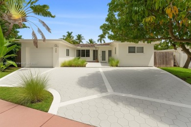 Beautiful light and bright pool home in a gated residential golf on Normandy Shores Golf Course in Florida - for sale on GolfHomes.com, golf home, golf lot