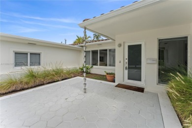 Beautiful light and bright pool home in a gated residential golf on Normandy Shores Golf Course in Florida - for sale on GolfHomes.com, golf home, golf lot