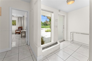 Beautiful light and bright pool home in a gated residential golf on Normandy Shores Golf Course in Florida - for sale on GolfHomes.com, golf home, golf lot