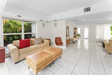 Beautiful light and bright pool home in a gated residential golf on Normandy Shores Golf Course in Florida - for sale on GolfHomes.com, golf home, golf lot