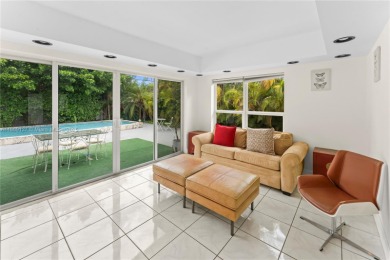 Beautiful light and bright pool home in a gated residential golf on Normandy Shores Golf Course in Florida - for sale on GolfHomes.com, golf home, golf lot
