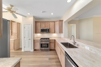 Welcome home and step into this popular Sanibel model on Eagle Ridge At Spruce Creek Country Club in Florida - for sale on GolfHomes.com, golf home, golf lot