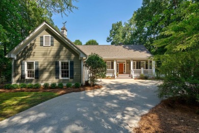 Discover timeless Southern elegance and luxury lakefront living on Great Waters Course At Reynolds Plantation in Georgia - for sale on GolfHomes.com, golf home, golf lot