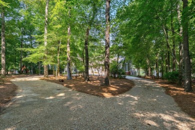 Discover timeless Southern elegance and luxury lakefront living on Great Waters Course At Reynolds Plantation in Georgia - for sale on GolfHomes.com, golf home, golf lot