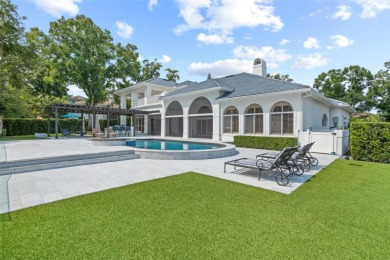 Stunning golf and lake views and beautifully updated grounds are on Isleworth Golf and Country Club in Florida - for sale on GolfHomes.com, golf home, golf lot