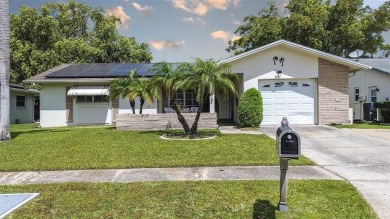 Nestled in the heart of Palm Harbor's sought-after Highland on Highland Lakes Executive Golf Course in Florida - for sale on GolfHomes.com, golf home, golf lot
