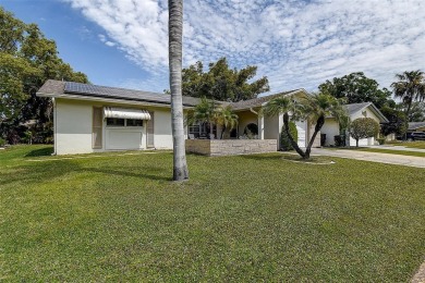 Nestled in the heart of Palm Harbor's sought-after Highland on Highland Lakes Executive Golf Course in Florida - for sale on GolfHomes.com, golf home, golf lot