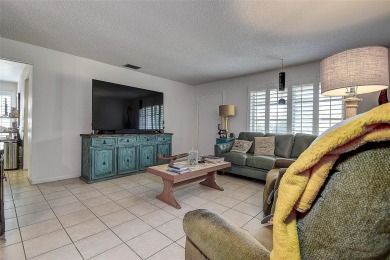 Nestled in the heart of Palm Harbor's sought-after Highland on Highland Lakes Executive Golf Course in Florida - for sale on GolfHomes.com, golf home, golf lot