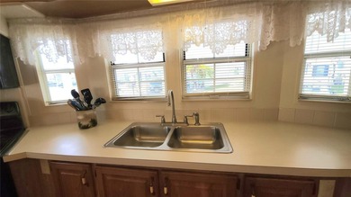 SO MUCH TO OFFER IN THIS ONE BEDROOM, 1 1/2 BATH MOBILE HOME IN on River Run Golf Links in Florida - for sale on GolfHomes.com, golf home, golf lot