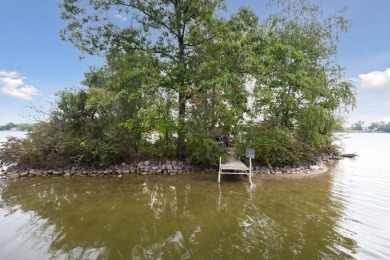 Comfortable and welcoming with 260 feet of water frontage, and on Island Hills Golf Club in Michigan - for sale on GolfHomes.com, golf home, golf lot