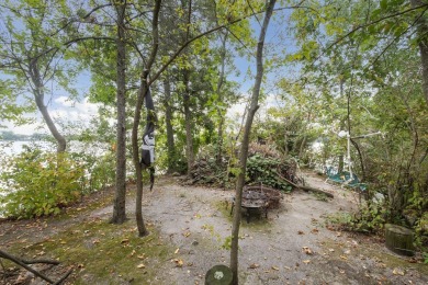 Comfortable and welcoming with 260 feet of water frontage, and on Island Hills Golf Club in Michigan - for sale on GolfHomes.com, golf home, golf lot