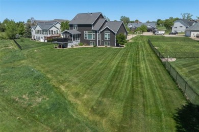 This beautiful 2-story home overlooks the par-3 4th hole at on Hunters Ridge Golf Course in Iowa - for sale on GolfHomes.com, golf home, golf lot
