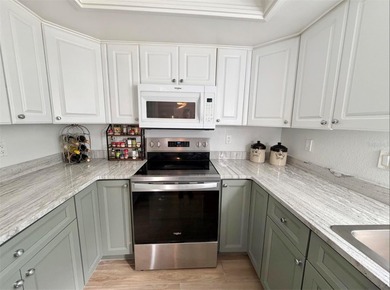 Charming and quiet 2-bedroom, 2-bath condo overlooking lush on Feather Sound Country Club in Florida - for sale on GolfHomes.com, golf home, golf lot