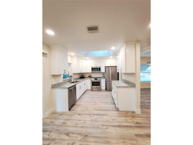 Discover your dream home in this beautifully remodeled 3-bedroom on Palm Harbor Golf Club in Florida - for sale on GolfHomes.com, golf home, golf lot