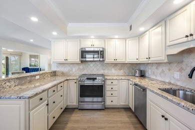 Experience the convenience of this renovated first-floor corner on Quail Ridge Golf Course and Country Club in Florida - for sale on GolfHomes.com, golf home, golf lot