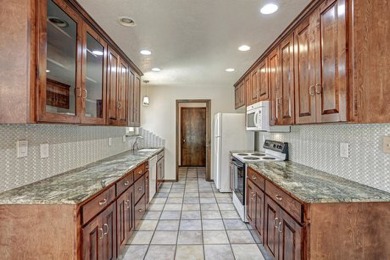 This lovely townhome in sought after Chimney Ridge sits directly on Arroyo Del Oso Golf Course in New Mexico - for sale on GolfHomes.com, golf home, golf lot