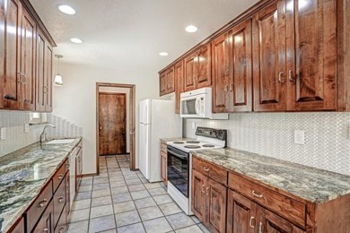 This lovely townhome in sought after Chimney Ridge sits directly on Arroyo Del Oso Golf Course in New Mexico - for sale on GolfHomes.com, golf home, golf lot