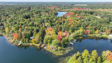 One of a kind Chain O'Lakes Home on a peninsula surrounded by on Foxfire Golf Club in Wisconsin - for sale on GolfHomes.com, golf home, golf lot
