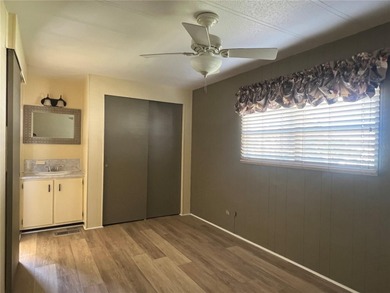 This charming double-wide home is ideally situated at the end of on Fairway Village Golf Course in Florida - for sale on GolfHomes.com, golf home, golf lot