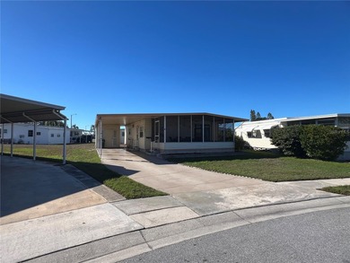 This charming double-wide home is ideally situated at the end of on Fairway Village Golf Course in Florida - for sale on GolfHomes.com, golf home, golf lot