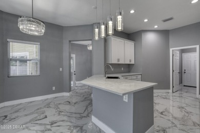 This newly remodeled 3-bedroom, 3-bathroom home in the desirable on The Grand Club - Pine Lakes Course in Florida - for sale on GolfHomes.com, golf home, golf lot