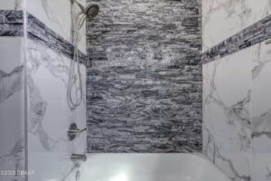 This newly remodeled 3-bedroom, 3-bathroom home in the desirable on The Grand Club - Pine Lakes Course in Florida - for sale on GolfHomes.com, golf home, golf lot