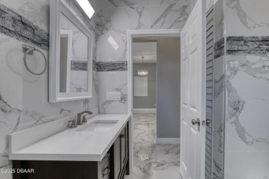 This newly remodeled 3-bedroom, 3-bathroom home in the desirable on The Grand Club - Pine Lakes Course in Florida - for sale on GolfHomes.com, golf home, golf lot
