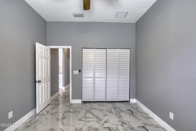 This newly remodeled 3-bedroom, 3-bathroom home in the desirable on The Grand Club - Pine Lakes Course in Florida - for sale on GolfHomes.com, golf home, golf lot