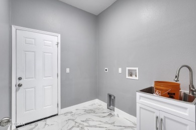 This newly remodeled 3-bedroom, 3-bathroom home in the desirable on The Grand Club - Pine Lakes Course in Florida - for sale on GolfHomes.com, golf home, golf lot