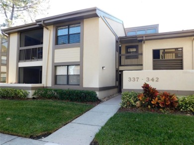 First floor end unit condo located in the Woodlake Run area of on East Lake Woodlands Country Club in Florida - for sale on GolfHomes.com, golf home, golf lot