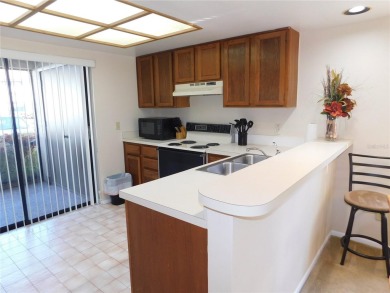 First floor end unit condo located in the Woodlake Run area of on East Lake Woodlands Country Club in Florida - for sale on GolfHomes.com, golf home, golf lot