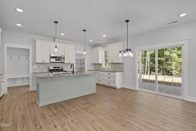 Welcome home to this spacious 4-bedroom, 2.5-bath residence on Olde Liberty Golf and Country Club in North Carolina - for sale on GolfHomes.com, golf home, golf lot