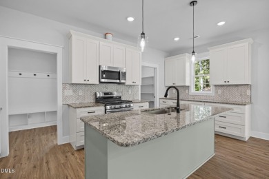 Welcome home to this spacious 4-bedroom, 2.5-bath residence on Olde Liberty Golf and Country Club in North Carolina - for sale on GolfHomes.com, golf home, golf lot