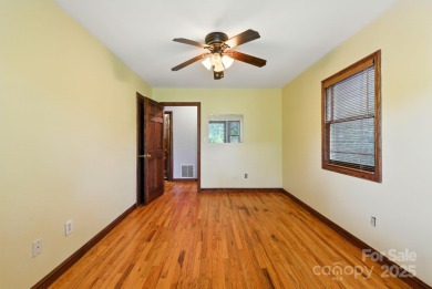 Nestled on a peaceful hilltop, this spacious 3-bedroom on Black Mountain Golf Course in North Carolina - for sale on GolfHomes.com, golf home, golf lot