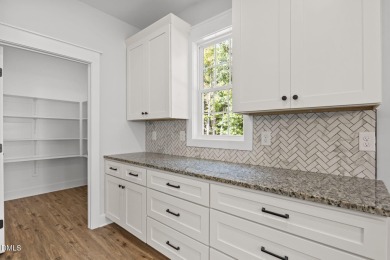 Welcome home to this spacious 4-bedroom, 2.5-bath residence on Olde Liberty Golf and Country Club in North Carolina - for sale on GolfHomes.com, golf home, golf lot