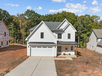 Welcome home to this spacious 4-bedroom, 2.5-bath residence on Olde Liberty Golf and Country Club in North Carolina - for sale on GolfHomes.com, golf home, golf lot