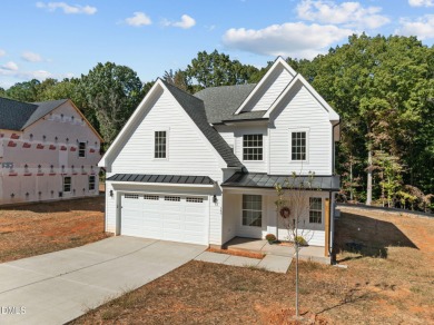 Welcome home to this spacious 4-bedroom, 2.5-bath residence on Olde Liberty Golf and Country Club in North Carolina - for sale on GolfHomes.com, golf home, golf lot