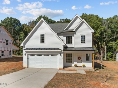 Welcome home to this spacious 4-bedroom, 2.5-bath residence on Olde Liberty Golf and Country Club in North Carolina - for sale on GolfHomes.com, golf home, golf lot