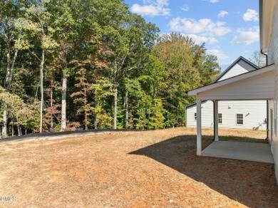 Welcome home to this spacious 4-bedroom, 2.5-bath residence on Olde Liberty Golf and Country Club in North Carolina - for sale on GolfHomes.com, golf home, golf lot