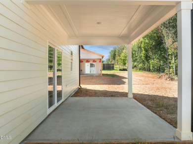 Welcome home to this spacious 4-bedroom, 2.5-bath residence on Olde Liberty Golf and Country Club in North Carolina - for sale on GolfHomes.com, golf home, golf lot
