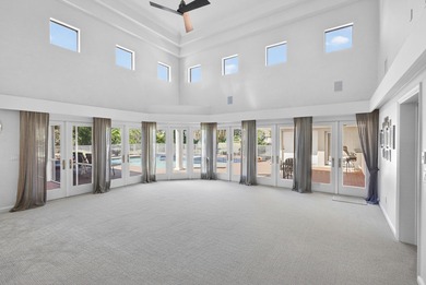 Set on 1.25 acres directly across from PGA National, this estate on  in Florida - for sale on GolfHomes.com, golf home, golf lot