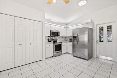 Discover the perfect blend of charm, comfort, and resort-style on Royal Oaks Golf Club in Florida - for sale on GolfHomes.com, golf home, golf lot