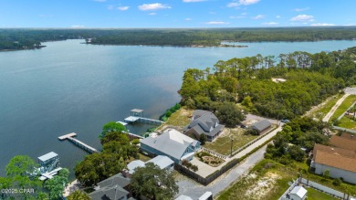 CUSTOM LAKE FRONT HOME WITH PRIVATE DOCK, BOATHOUSE FEATURING 6K on Sharks Tooth Golf Club in Florida - for sale on GolfHomes.com, golf home, golf lot