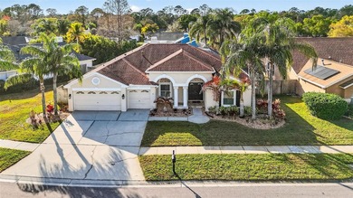 Situated on a rare 10,000+ sq ft lot in Westchase, this heated on Westchase Golf Club in Florida - for sale on GolfHomes.com, golf home, golf lot