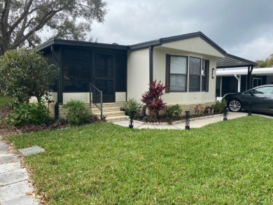 THIS SPECTACULAR 2/2 WITH A 12 X 24 SCREEN ROOM IS SELLING FOR on Lake Henry Golf Club in Florida - for sale on GolfHomes.com, golf home, golf lot