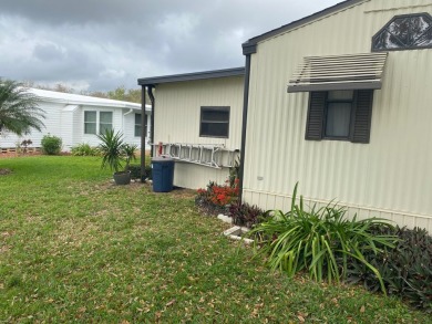 THIS SPECTACULAR 2/2 WITH A 12 X 24 SCREEN ROOM IS SELLING FOR on Lake Henry Golf Club in Florida - for sale on GolfHomes.com, golf home, golf lot