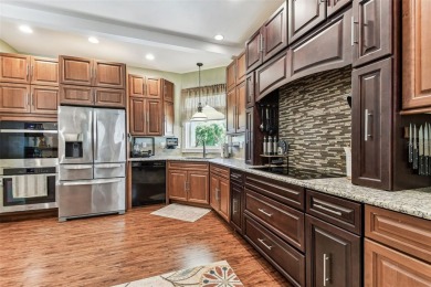 Nestled on a beautifully positioned corner lot directly across on Clearwater Country Club in Florida - for sale on GolfHomes.com, golf home, golf lot