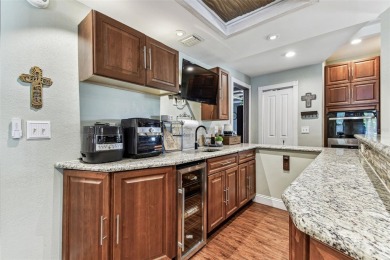 Nestled on a beautifully positioned corner lot directly across on Clearwater Country Club in Florida - for sale on GolfHomes.com, golf home, golf lot