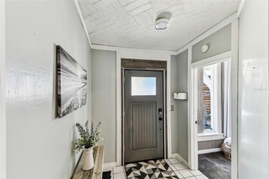 Nestled on a beautifully positioned corner lot directly across on Clearwater Country Club in Florida - for sale on GolfHomes.com, golf home, golf lot